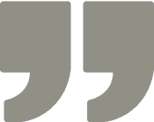 Gray quotation marks on a black background.